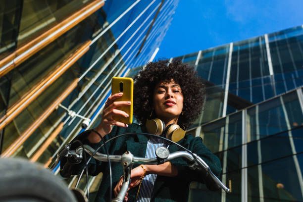 A woman is riding a bike and taking a selfie with her cell phone.- Mental Health Condition Treatment in Pittsburgh, PA