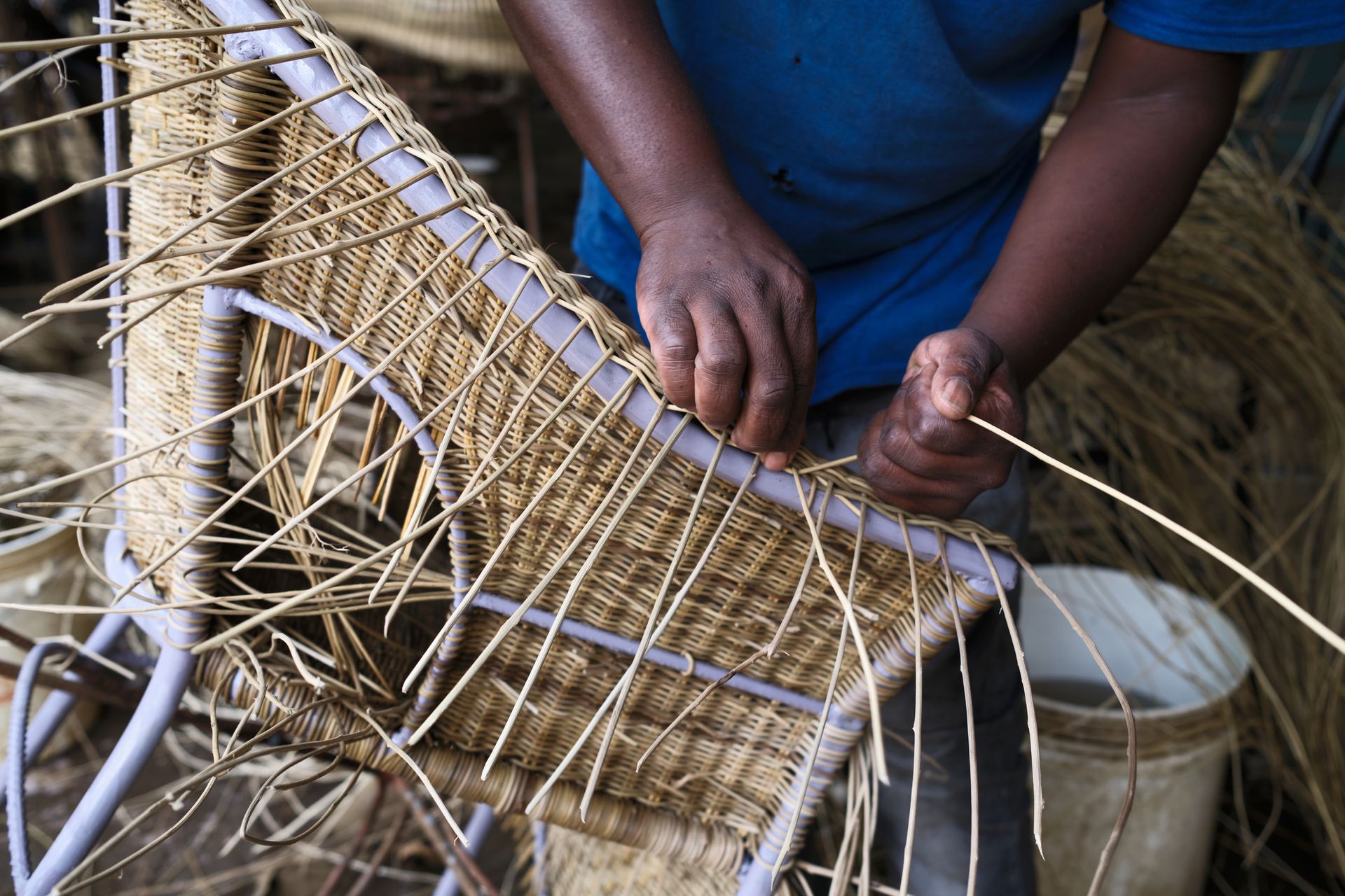 Artisan hands crafting traditional wicker furniture. Artisan hands crafting traditional wicker furniture.