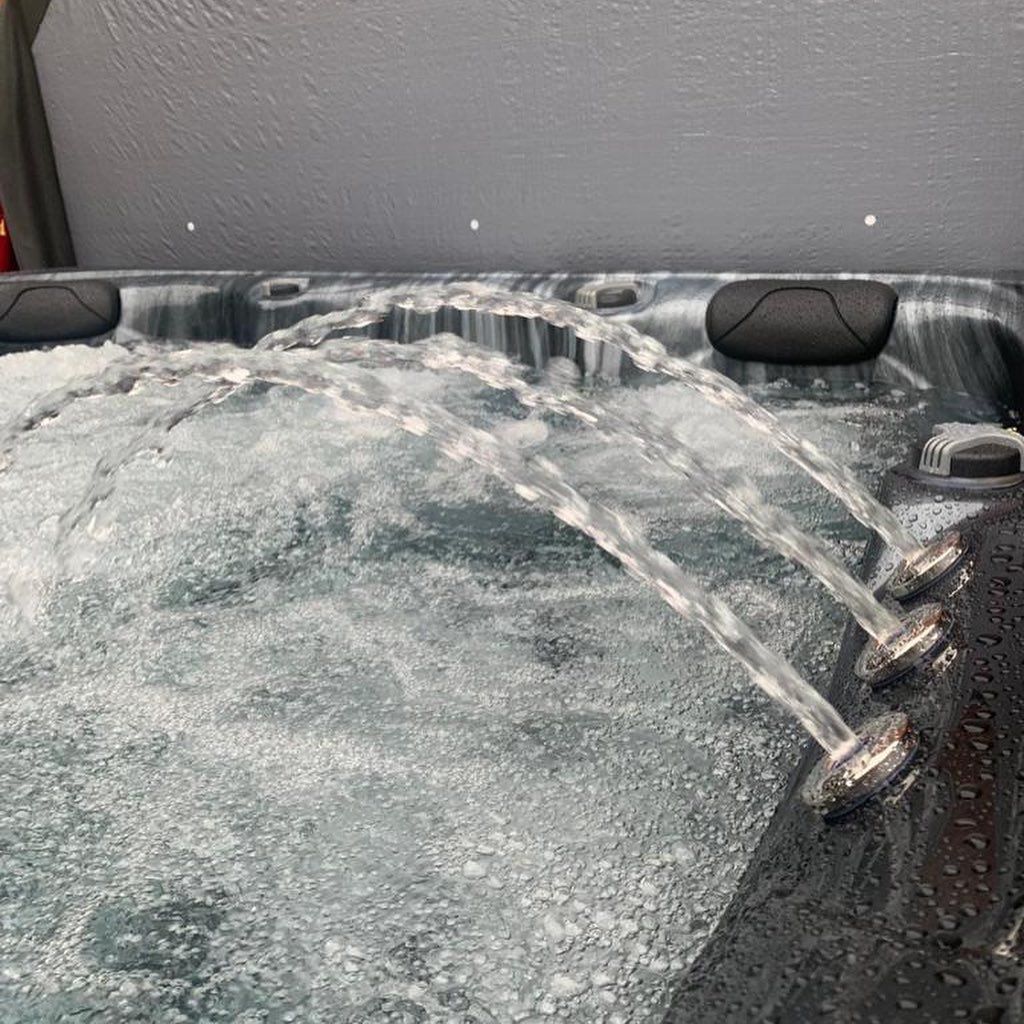 Hot tub with water jets spraying into bubbling water.