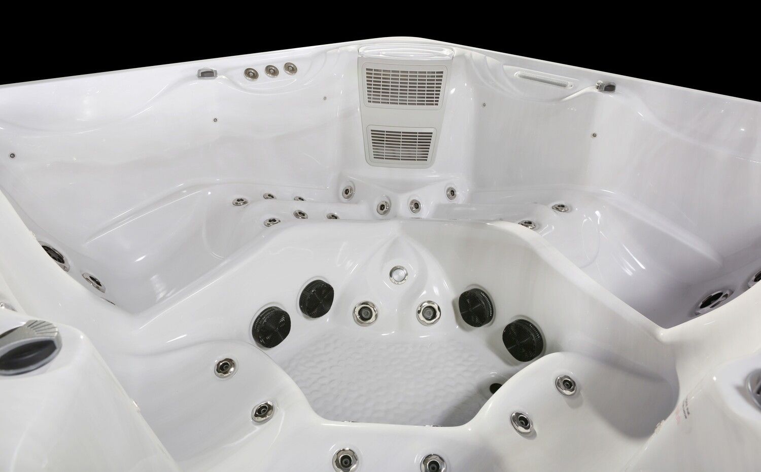 White hot tub interior with various jets and a corner seating design.