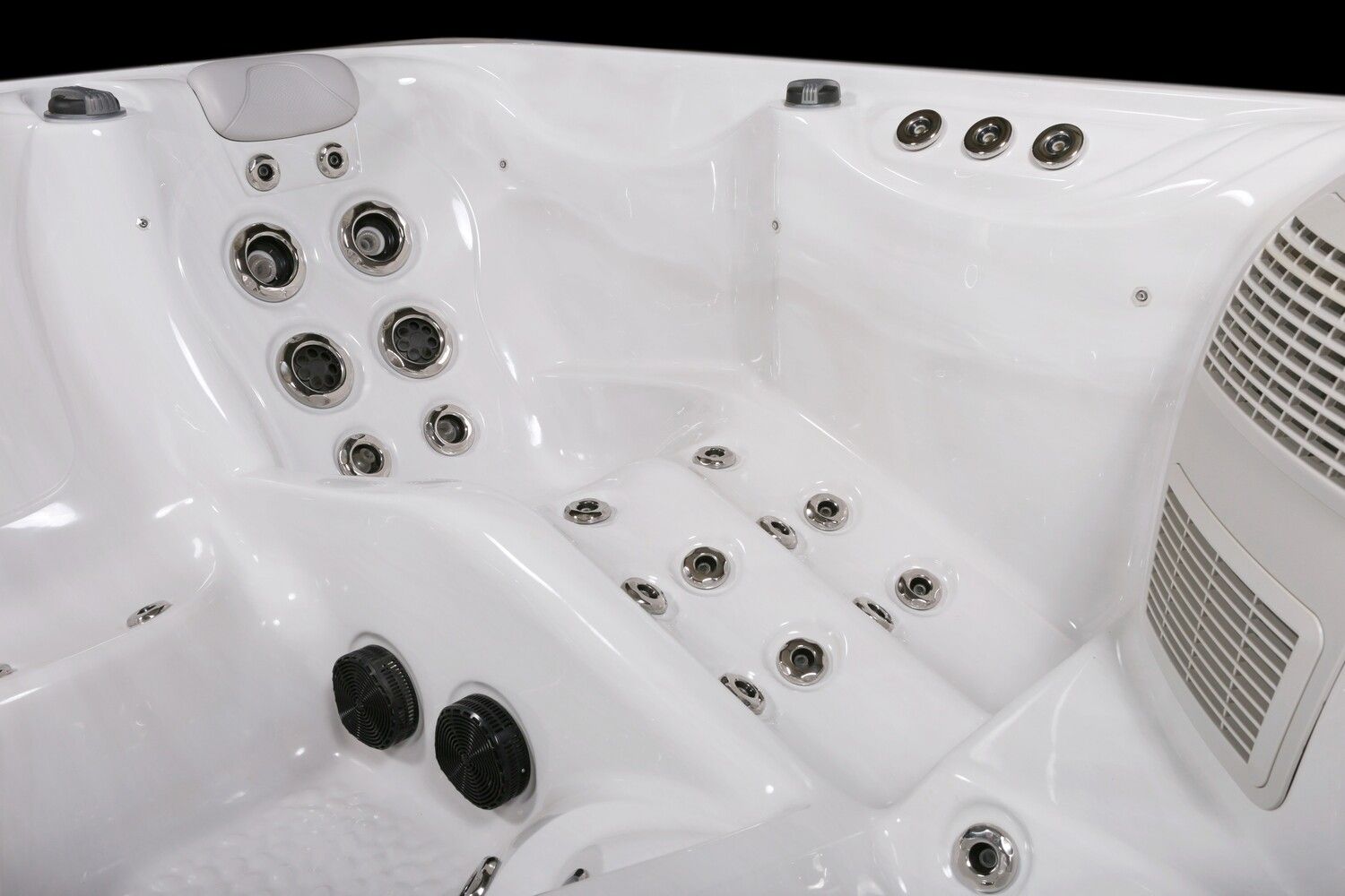 White hot tub interior with multiple jet nozzles.