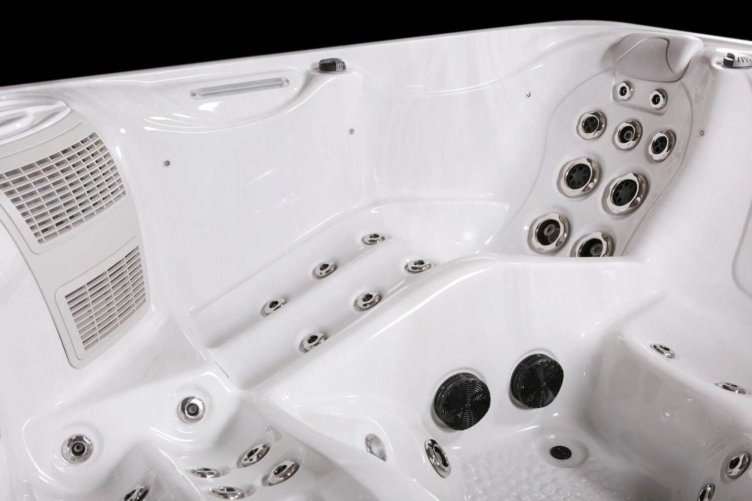 White hot tub interior with multiple jets and seating, black background.