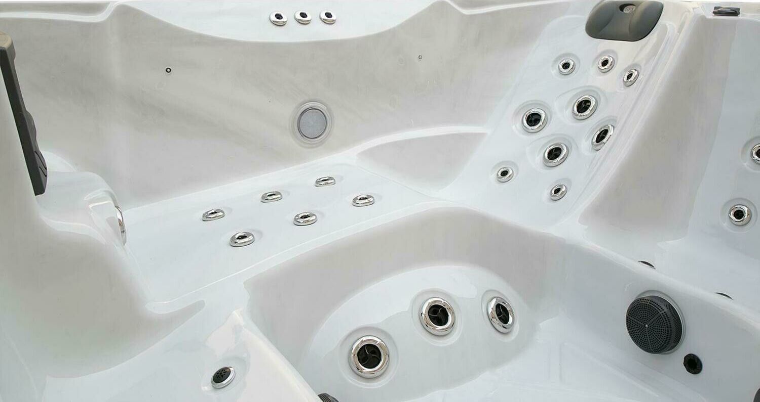 White hot tub interior with multiple jets.