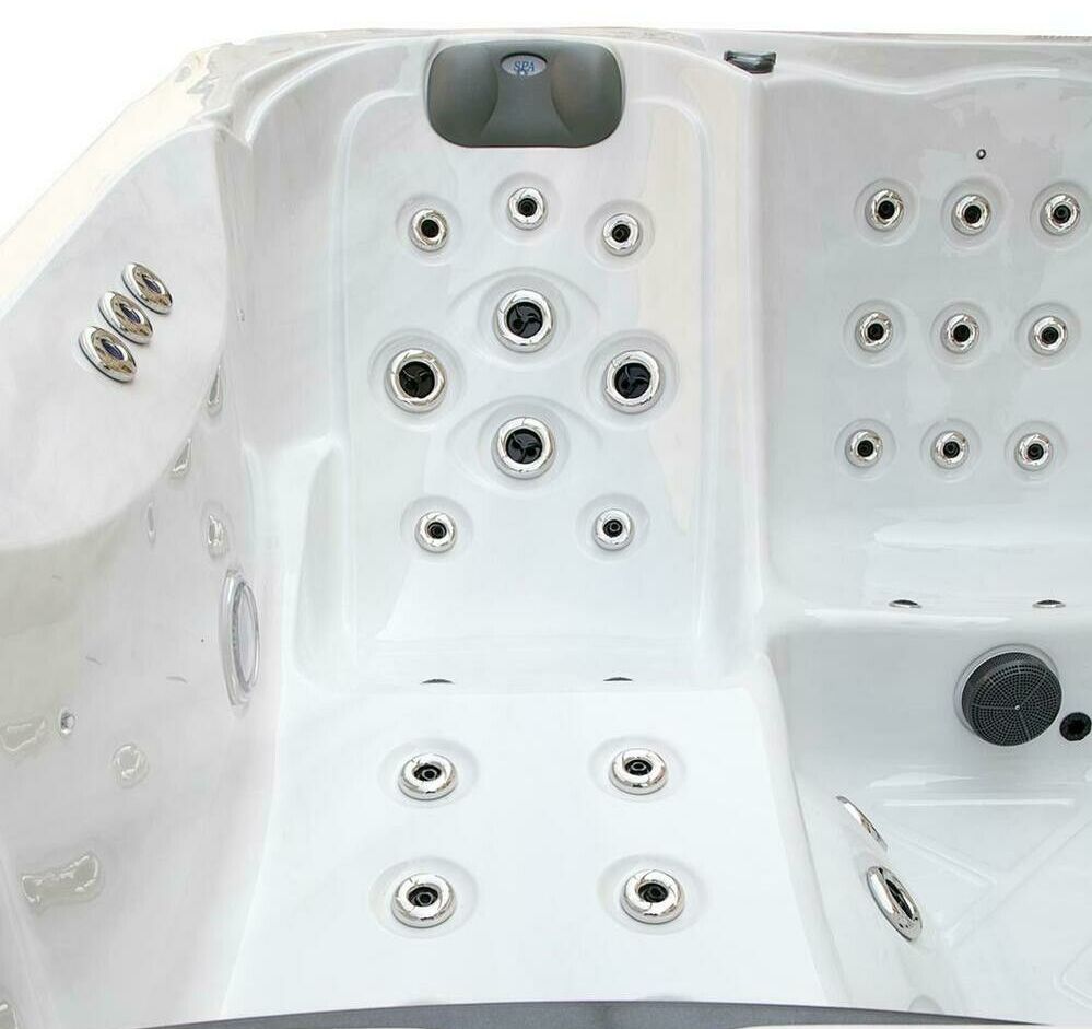 White hot tub interior with numerous jets.