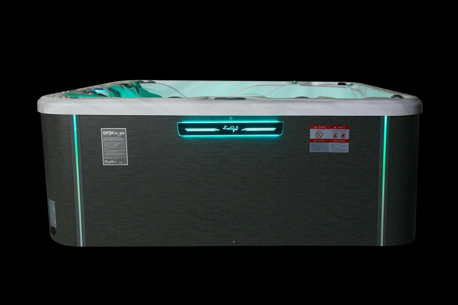 Hot tub with teal and white accents, illuminated with blue lights.