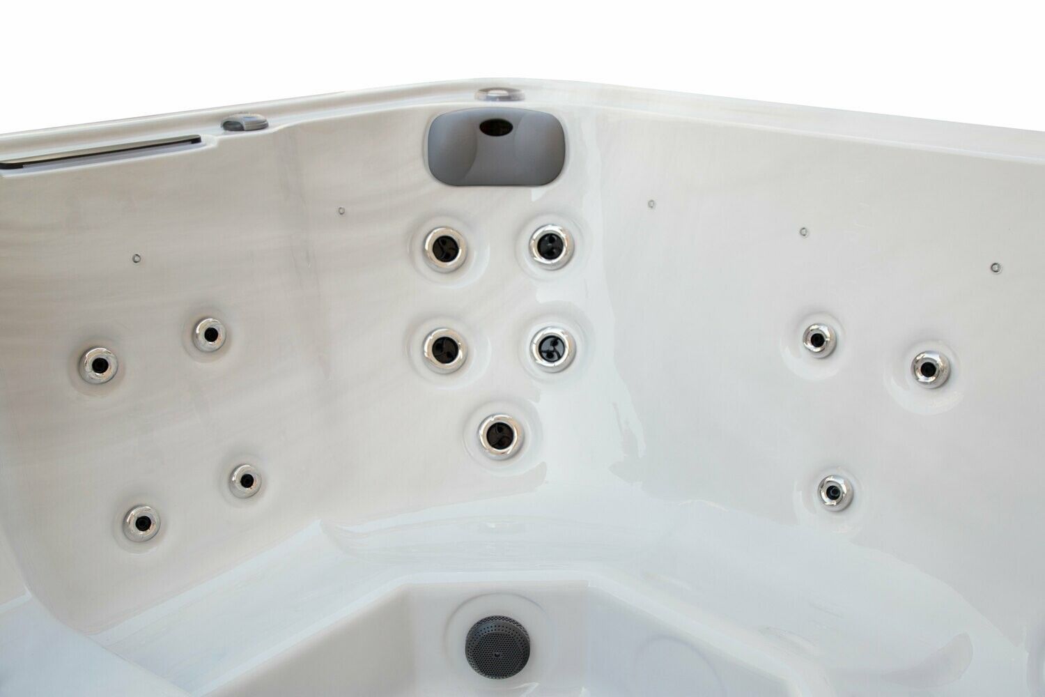 Interior view of a white hot tub with multiple jets and controls.
