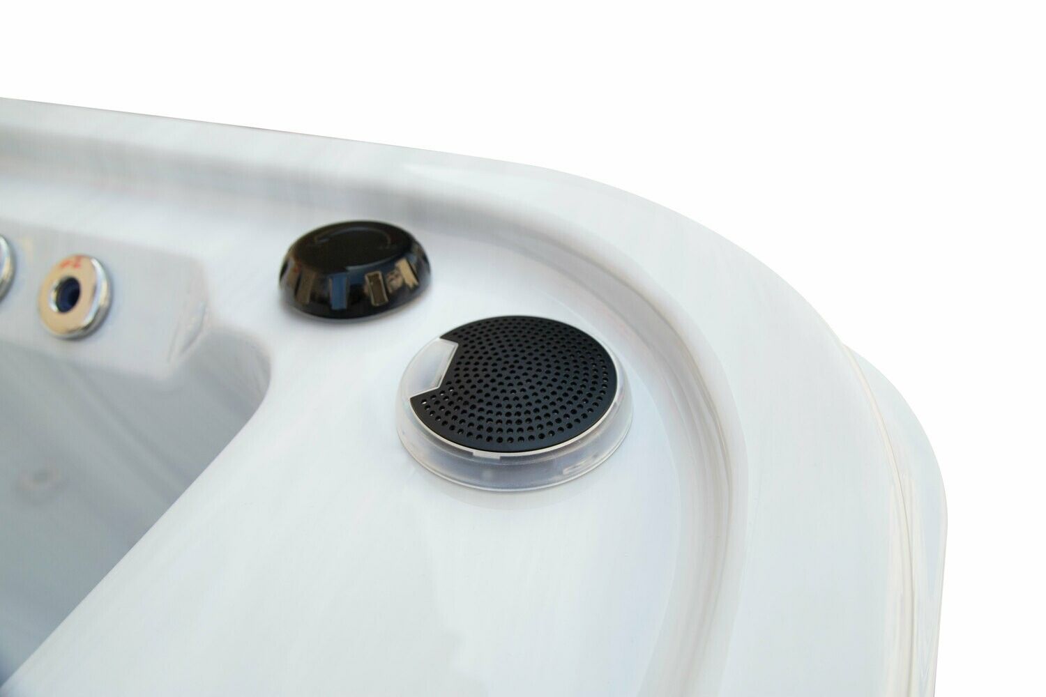 Close-up of a white hot tub with two black control buttons on the edge.