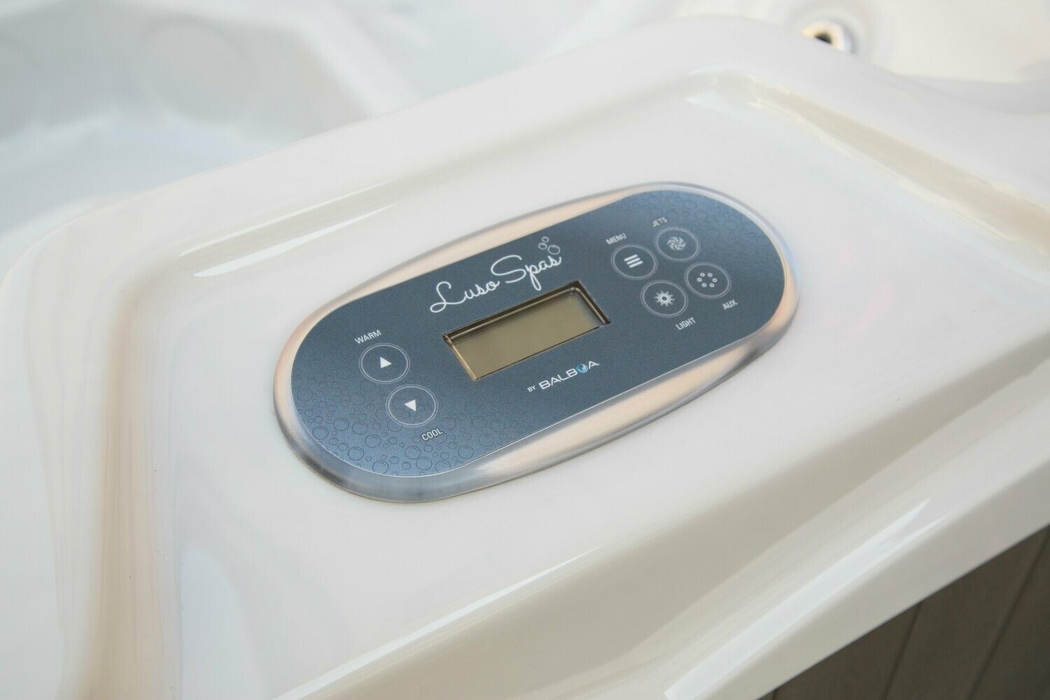 Hot tub control panel with digital display and buttons.