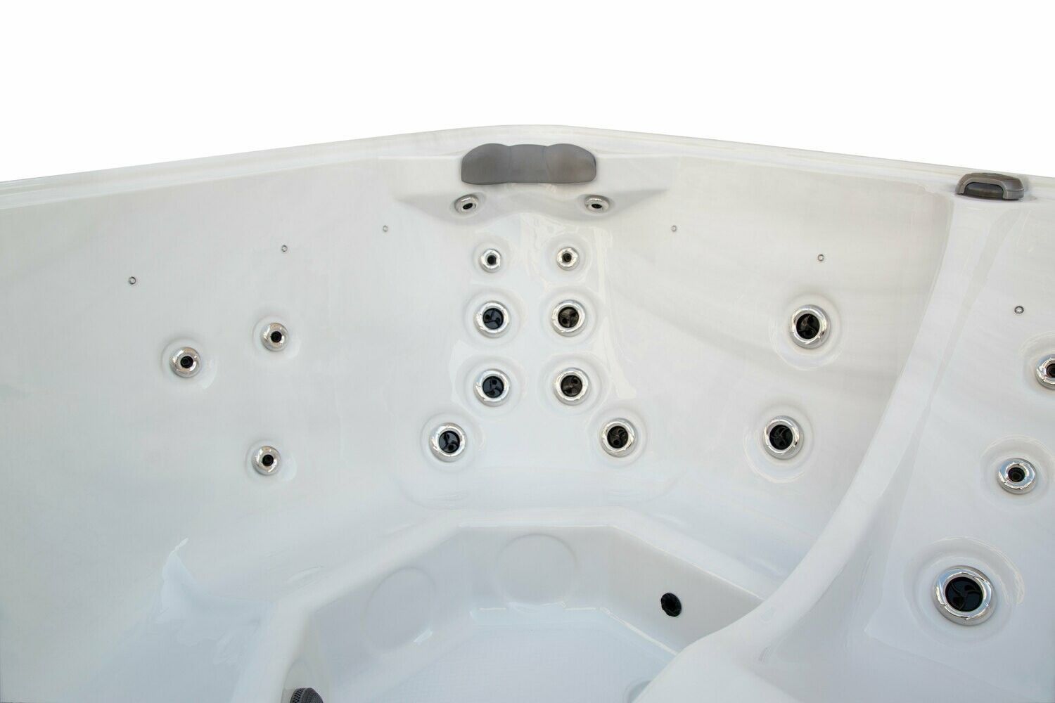 Interior view of a white hot tub with multiple jet nozzles and seating areas.