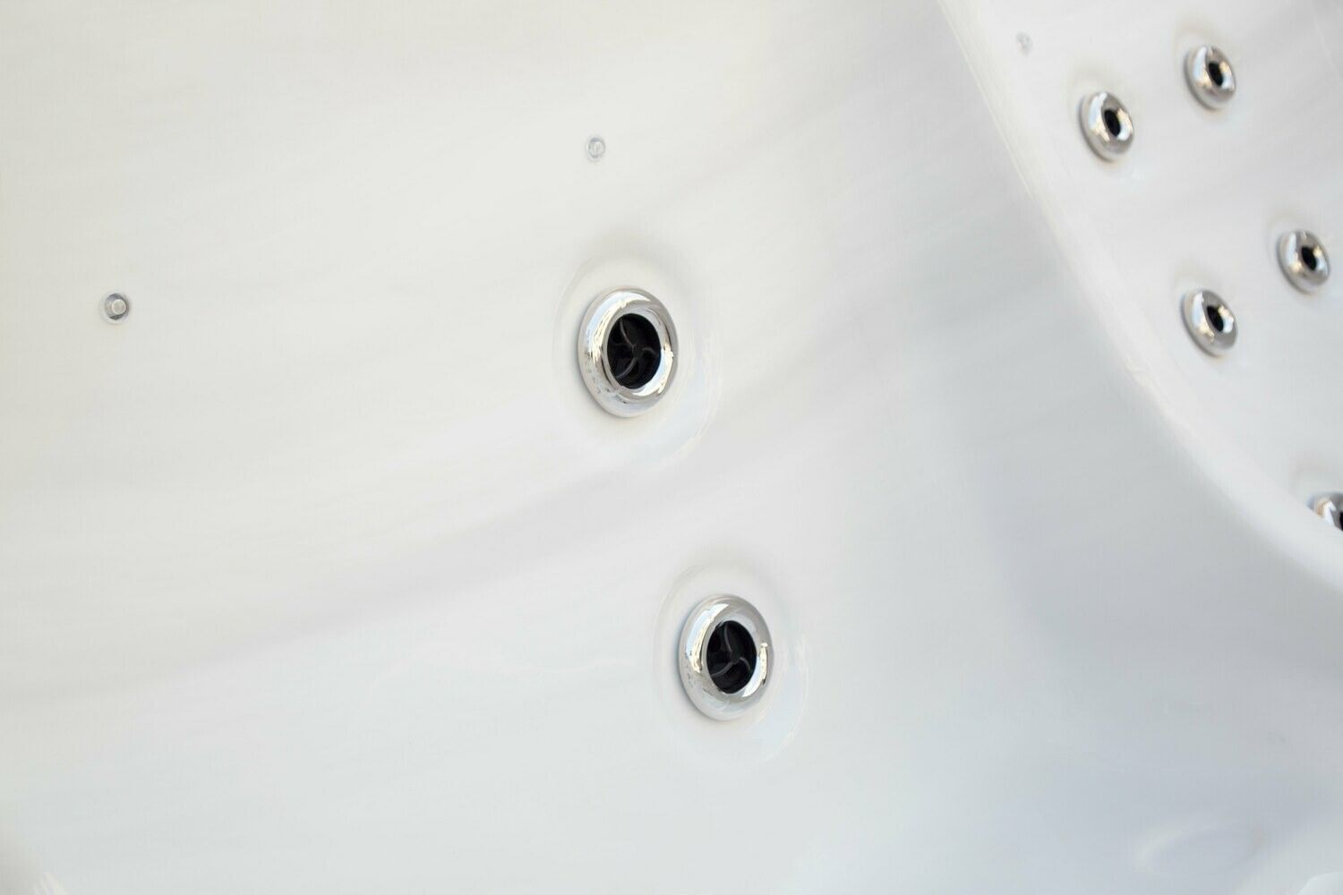White hot tub interior with several water jets.