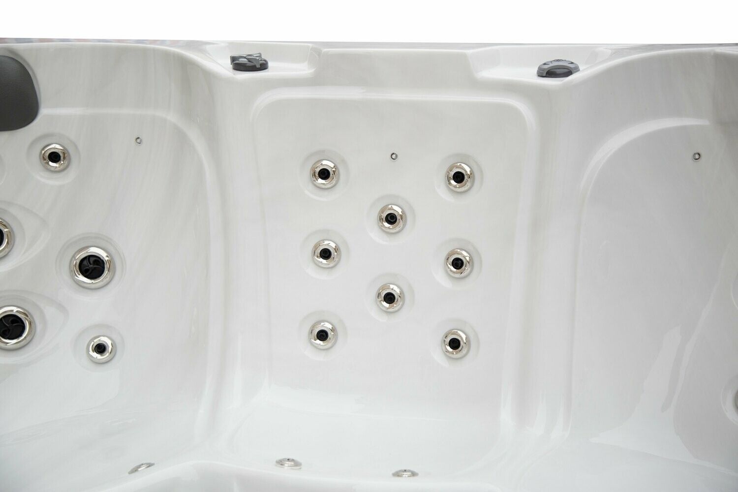 Close-up of a white hot tub interior with multiple jets.