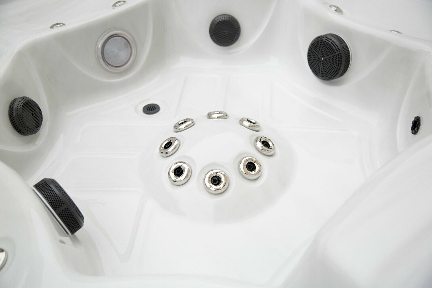 White hot tub interior with jets and control knobs.