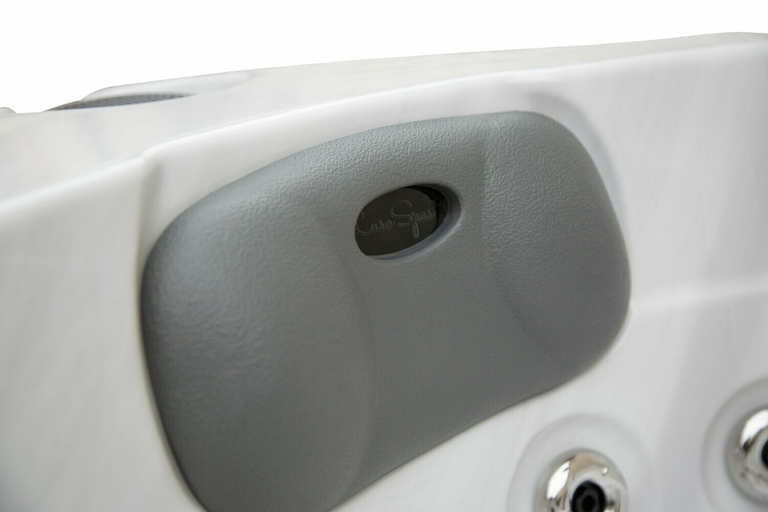 Gray hot tub headrest with a hole, set against a white tub interior.
