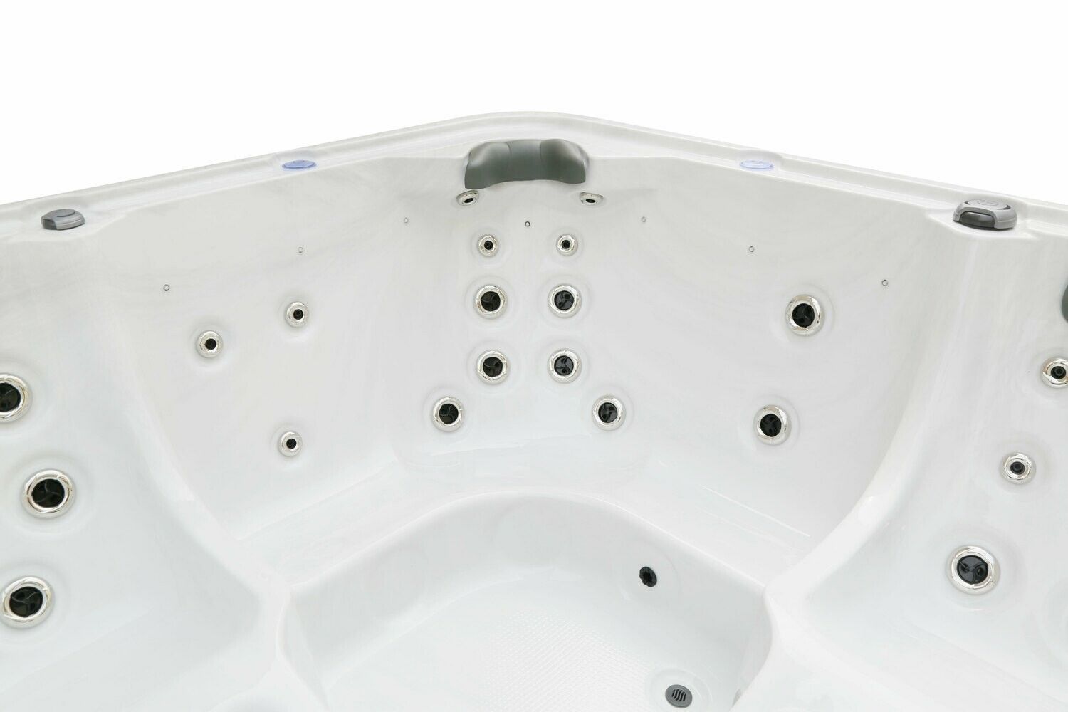 Close-up of a white hot tub interior, showing jets and seating areas.