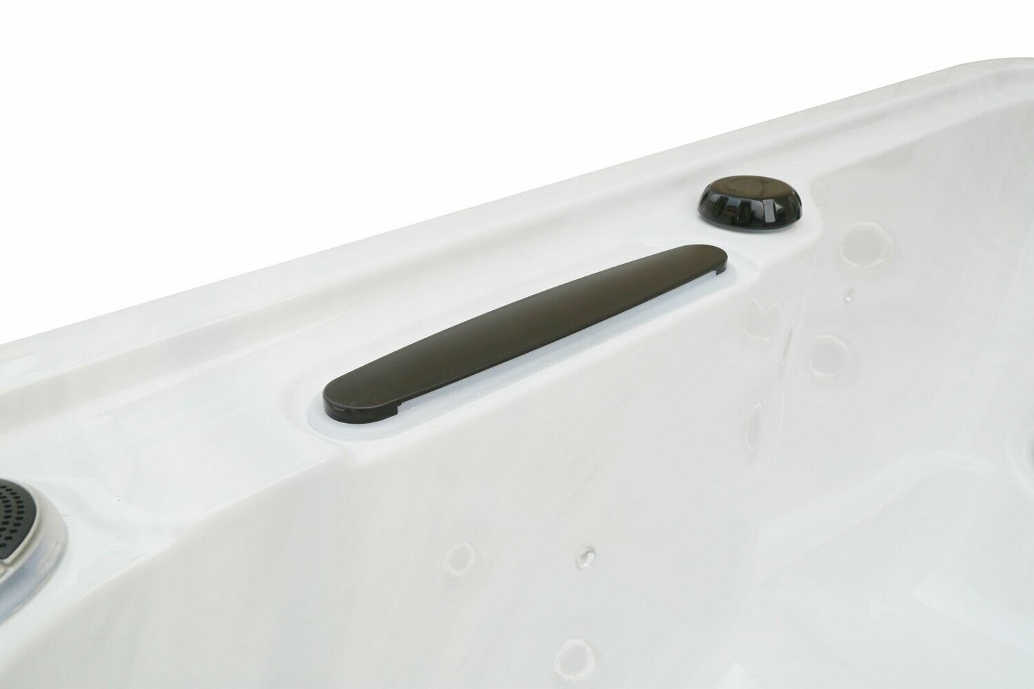 Close-up of a white hot tub interior with a black grab bar and a black control button.