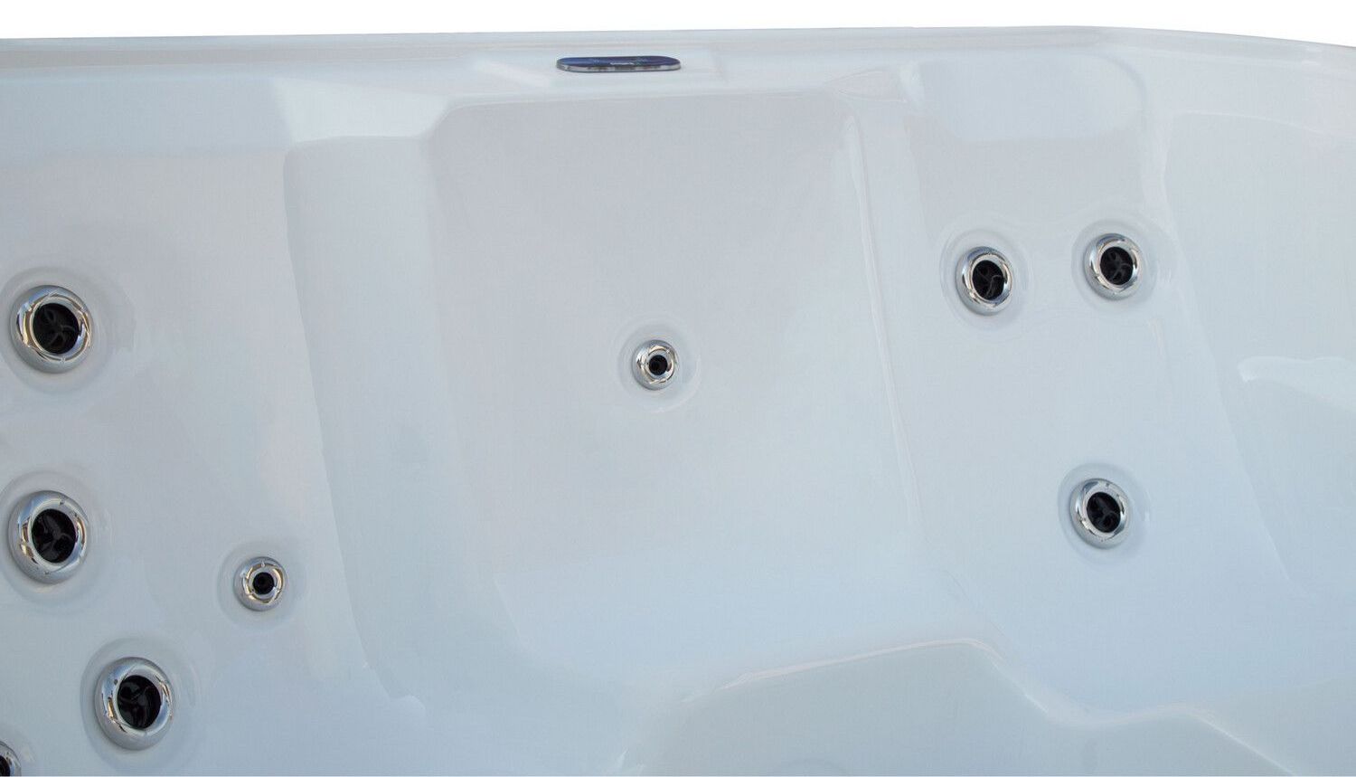 Close-up of a white hot tub interior with several jet nozzles.