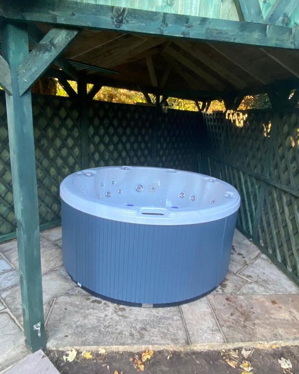 Hot tub in a gazebo, blue and gray colors.
