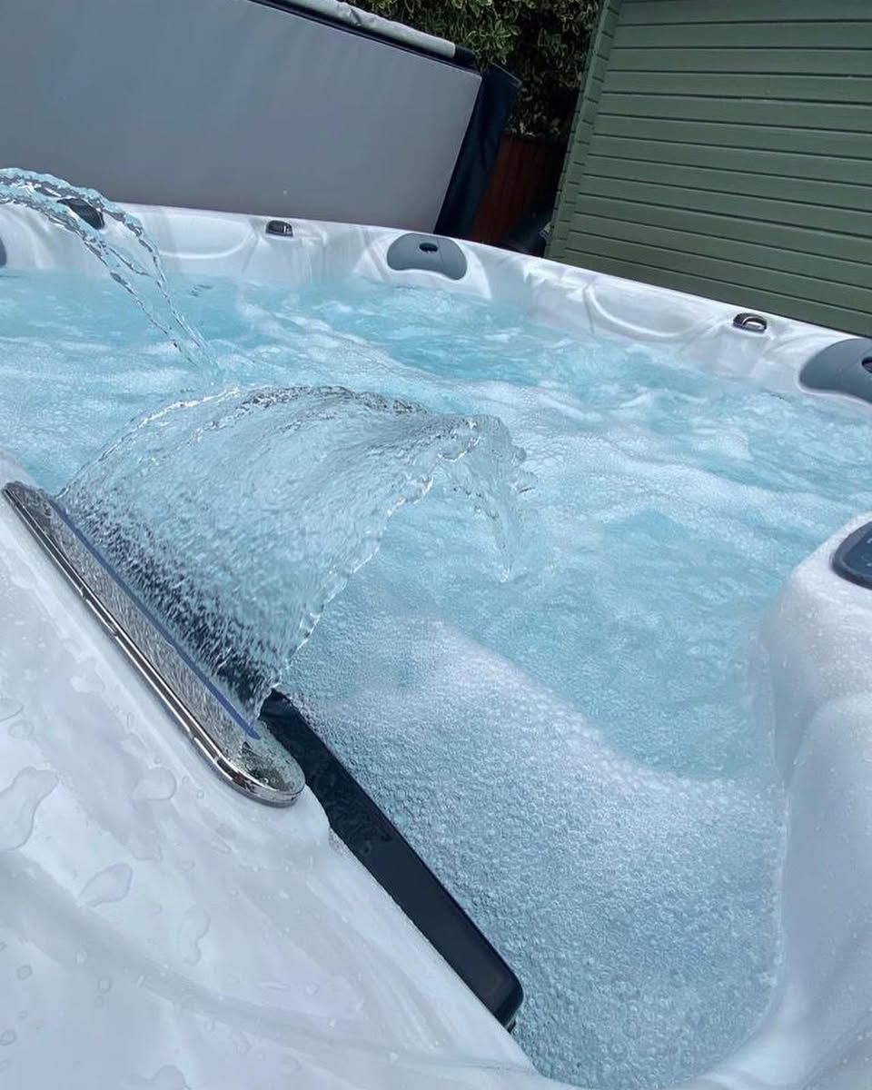 Hot tub with water jets active, splashing water, close-up view.