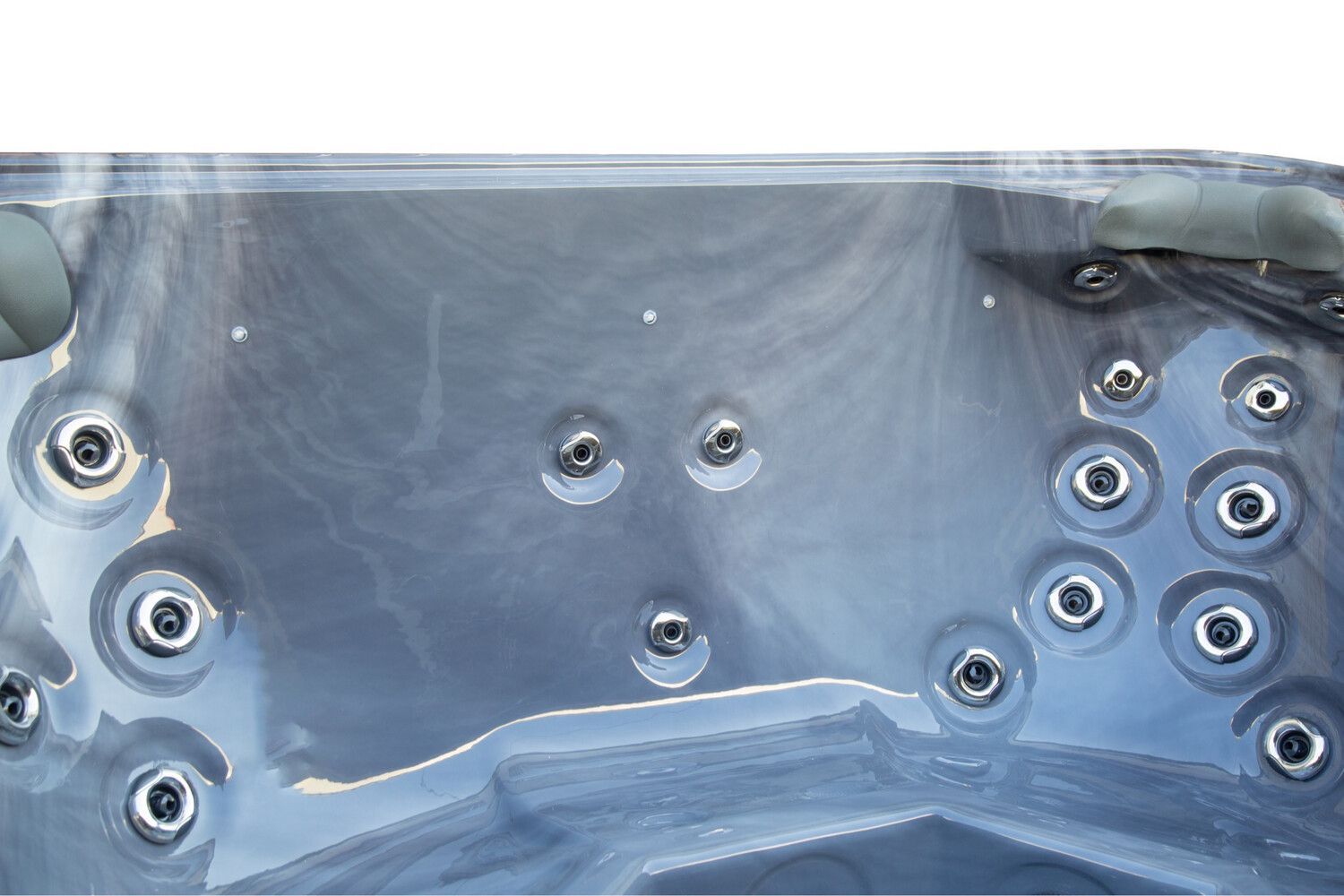 Close-up view of a hot tub interior with several water jets. The surface is marbled gray.