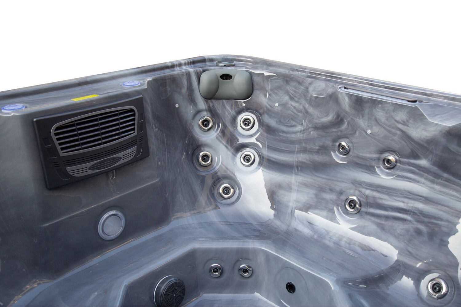 Interior of a dark marbled hot tub with jet nozzles, air vent, and rounded corners.