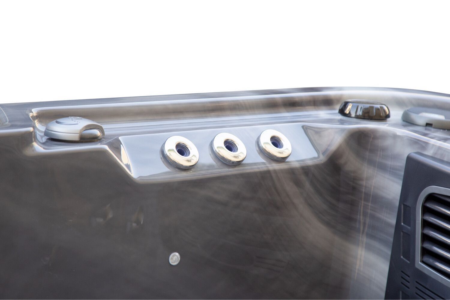 Close-up of hot tub jets and control panel. Gray-blue tub with three silver jets and a nearby vent.