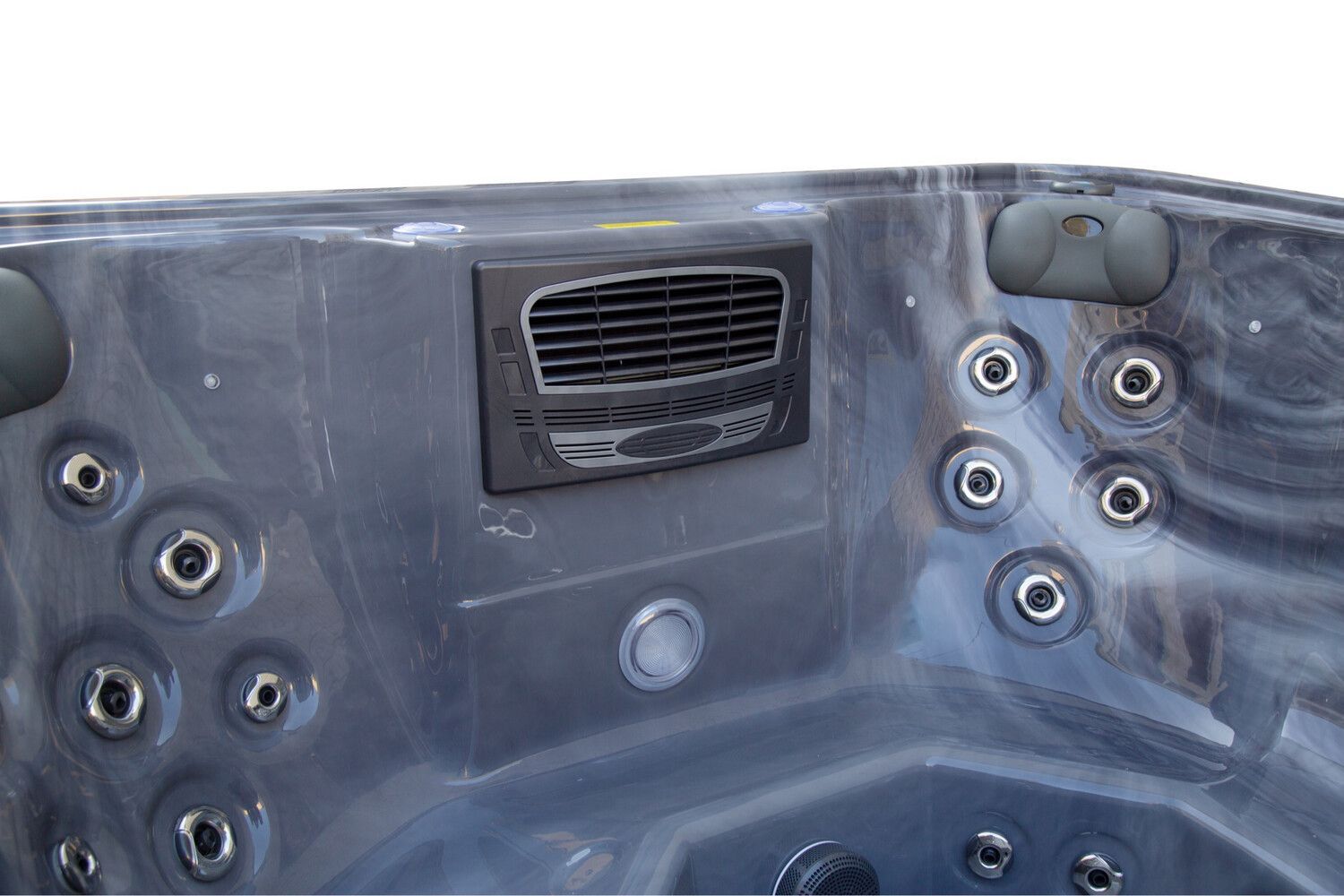 Close-up of a hot tub interior with gray jets, control panel, and vent.