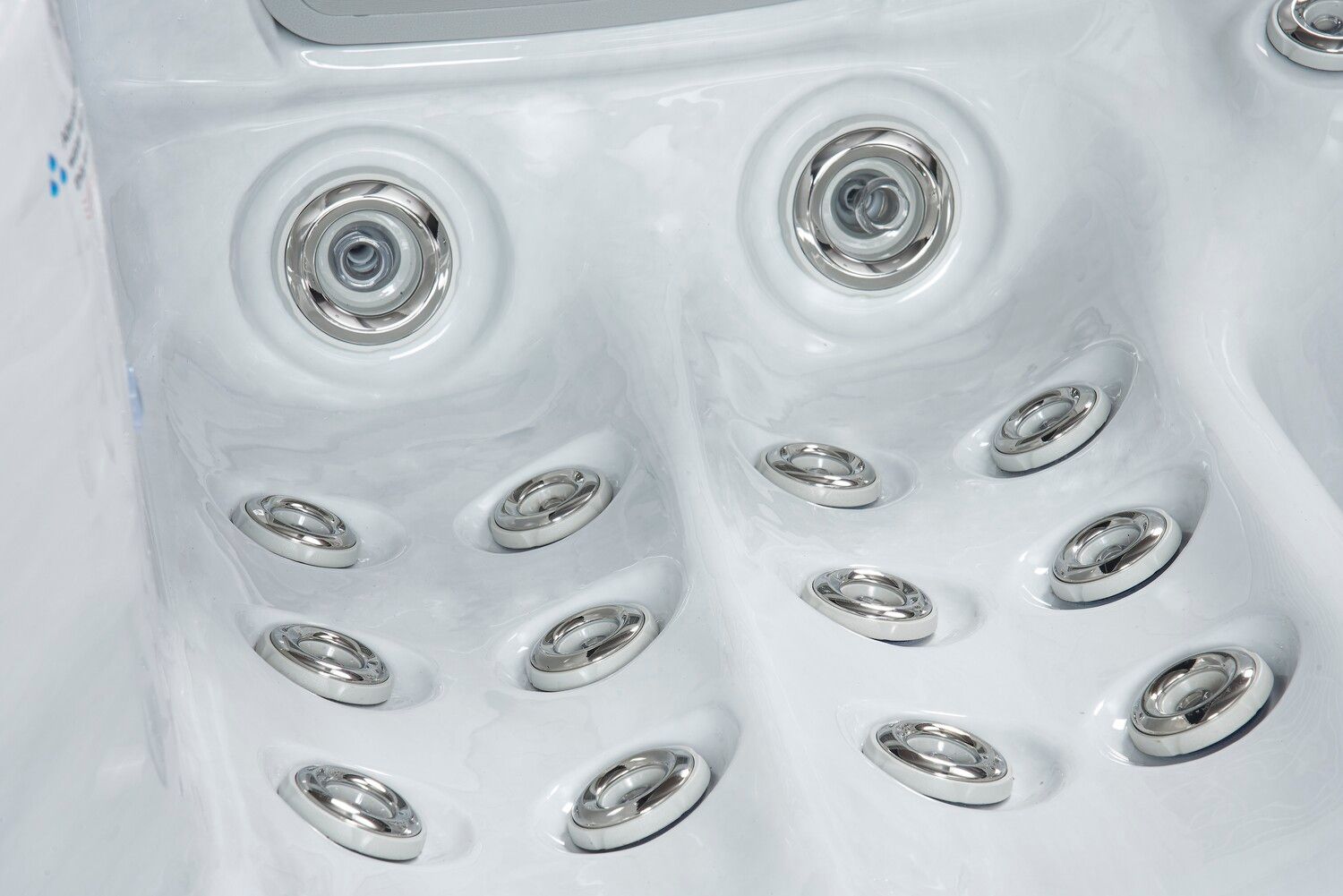White hot tub interior with multiple silver jets.
