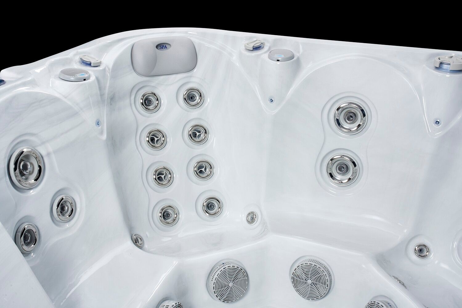 White hot tub interior with numerous silver jets against a black background.