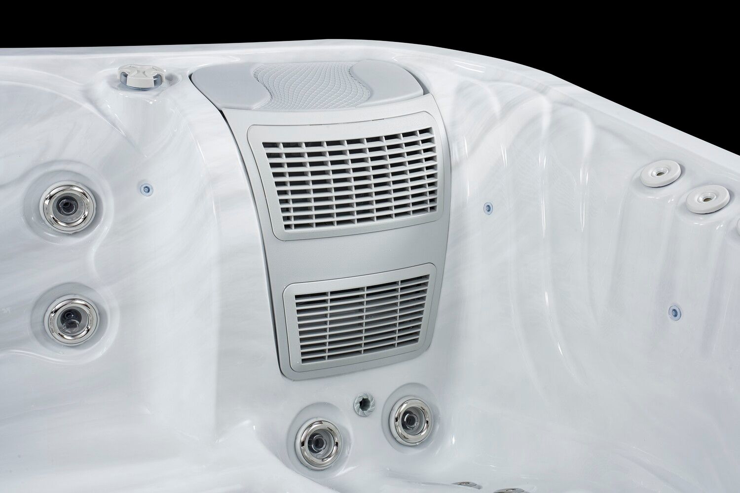 White hot tub interior with gray speaker system and jets.