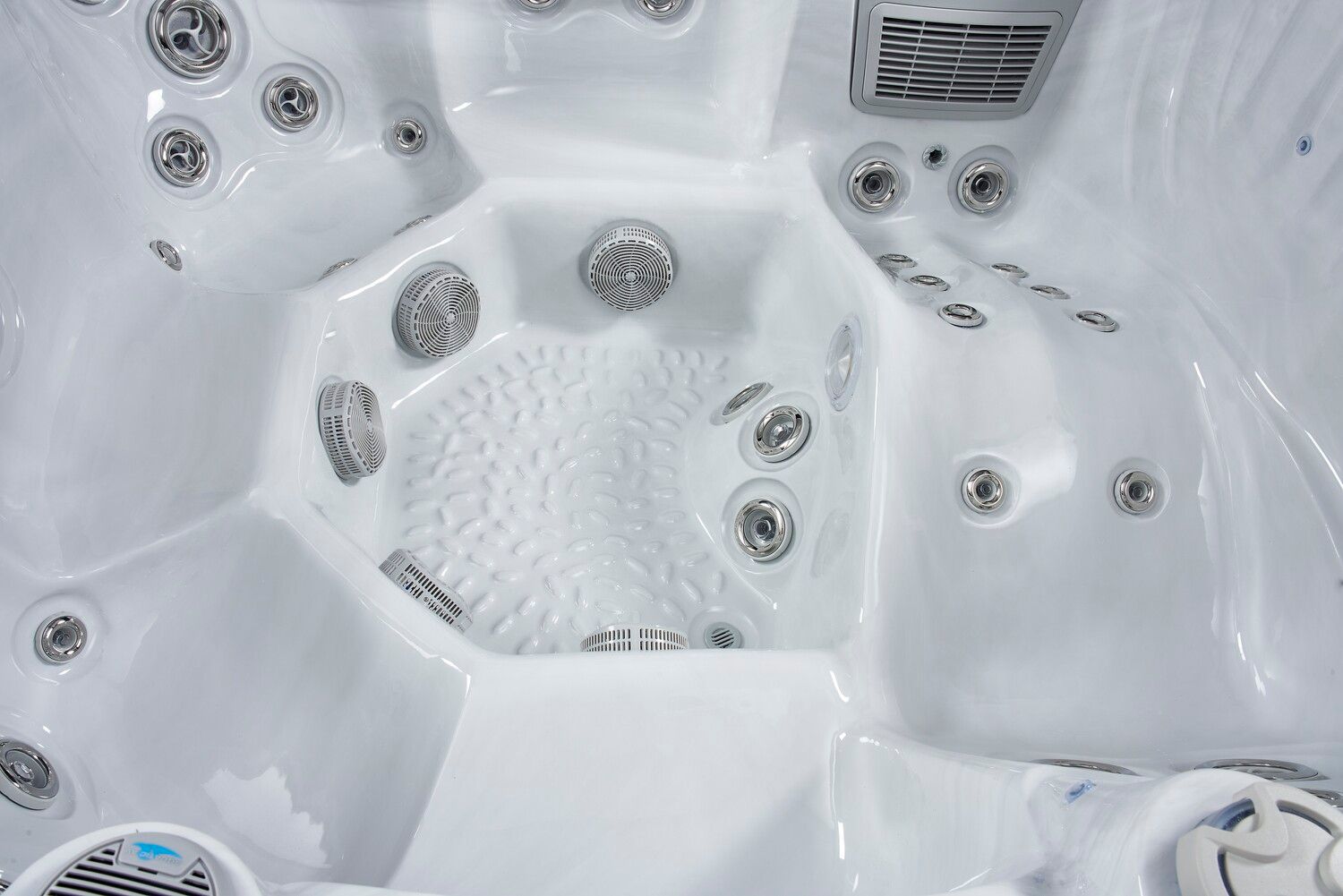 White hot tub interior with numerous jets and seating areas.