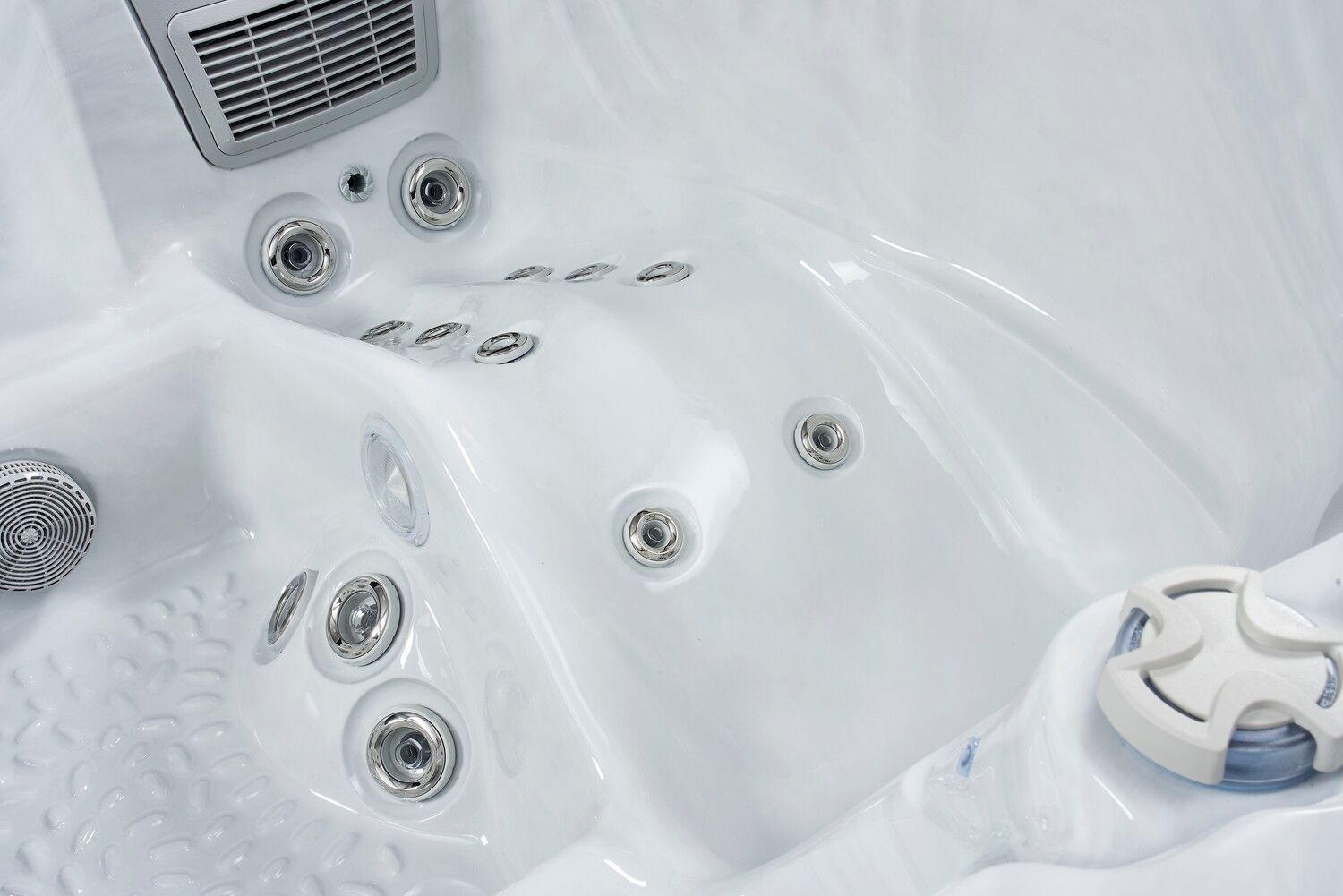 White hot tub interior with several water jets.