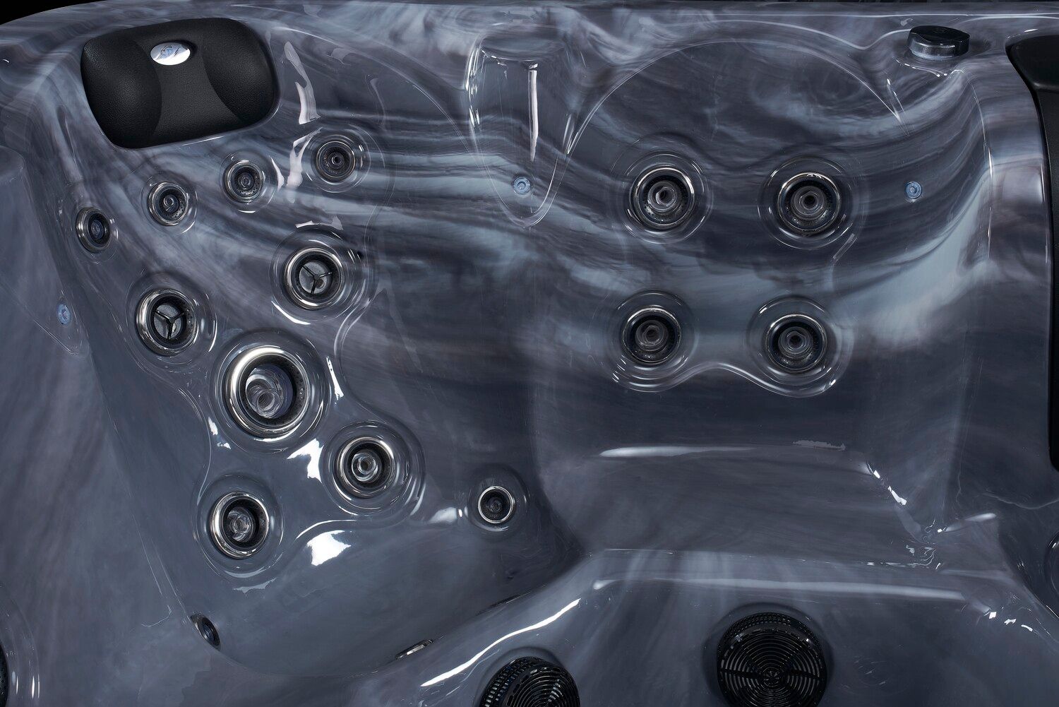 Dark gray hot tub interior with multiple water jets.