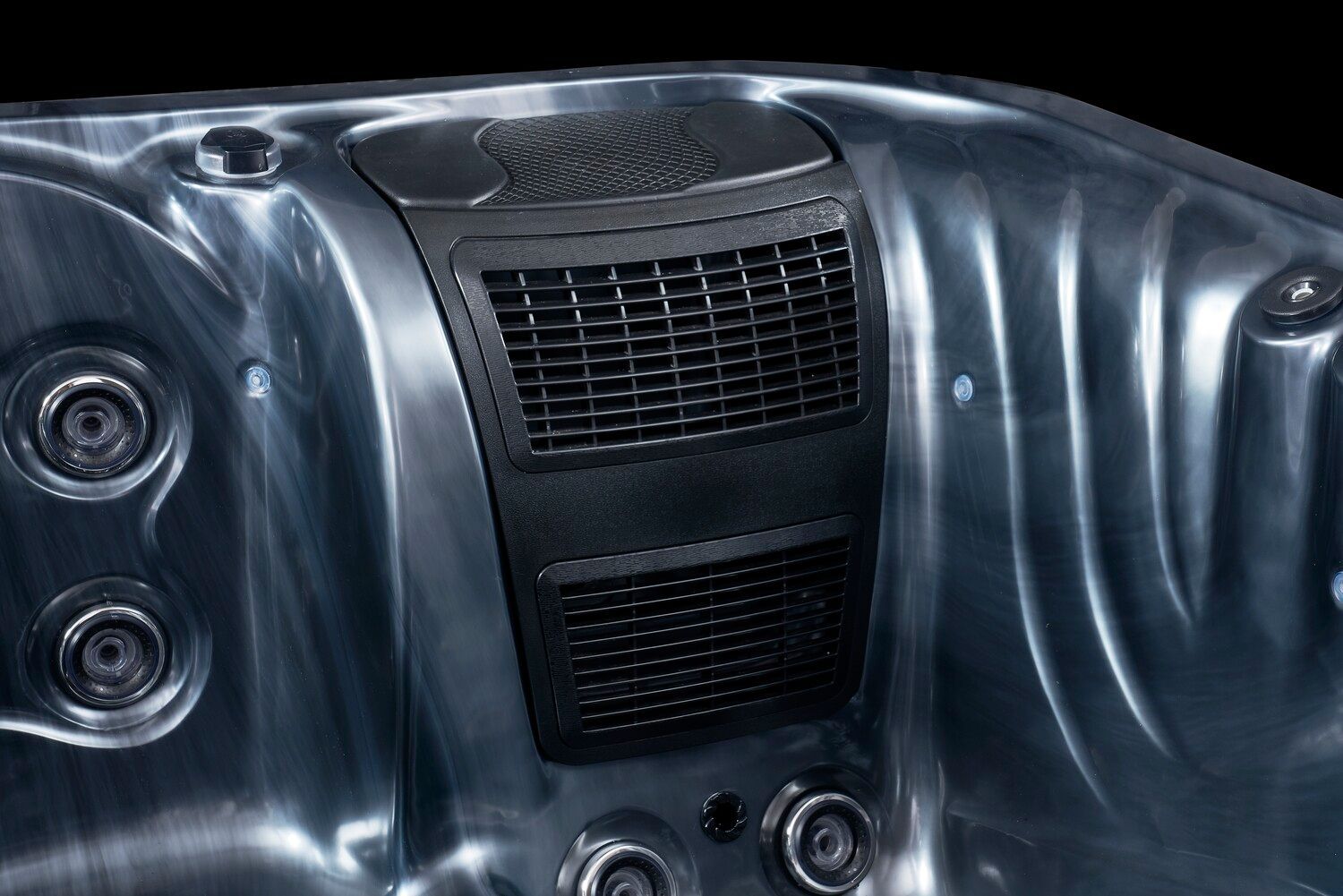 Close-up of a dark gray hot tub interior with jets and a central black vent.
