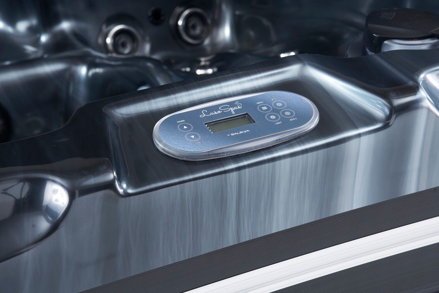 Hot tub control panel with digital display and buttons.