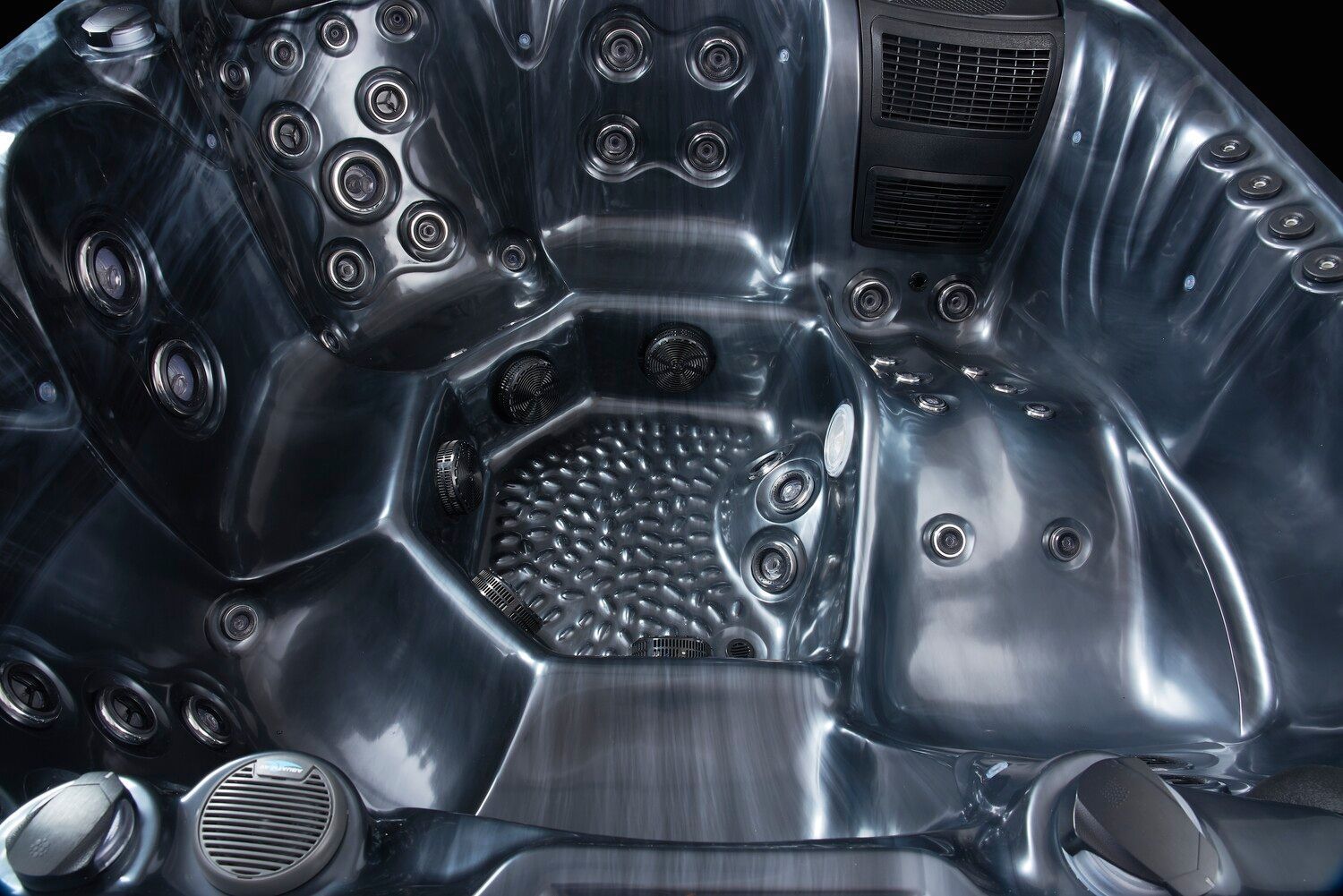 Dark gray hot tub interior with many jets and molded seating.