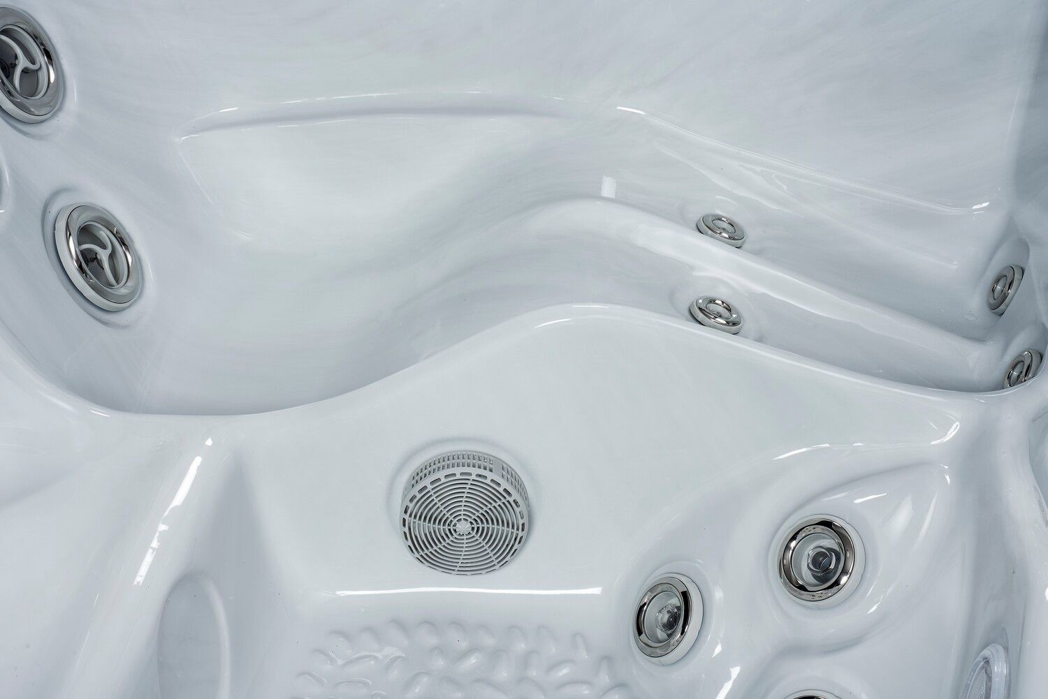 White hot tub interior with multiple jets and seating contours.