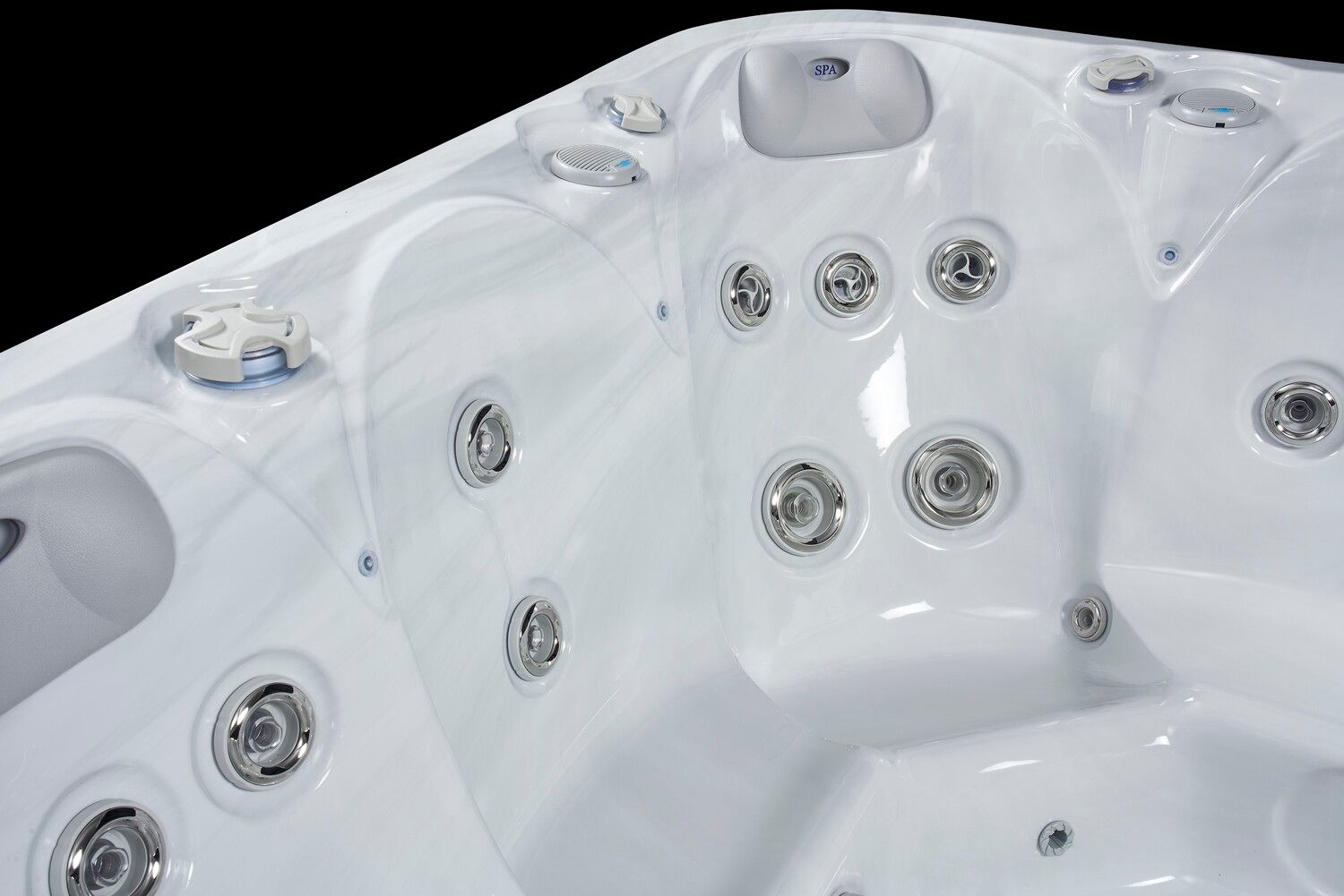 Close-up of a white hot tub interior with several water jets against a black background.