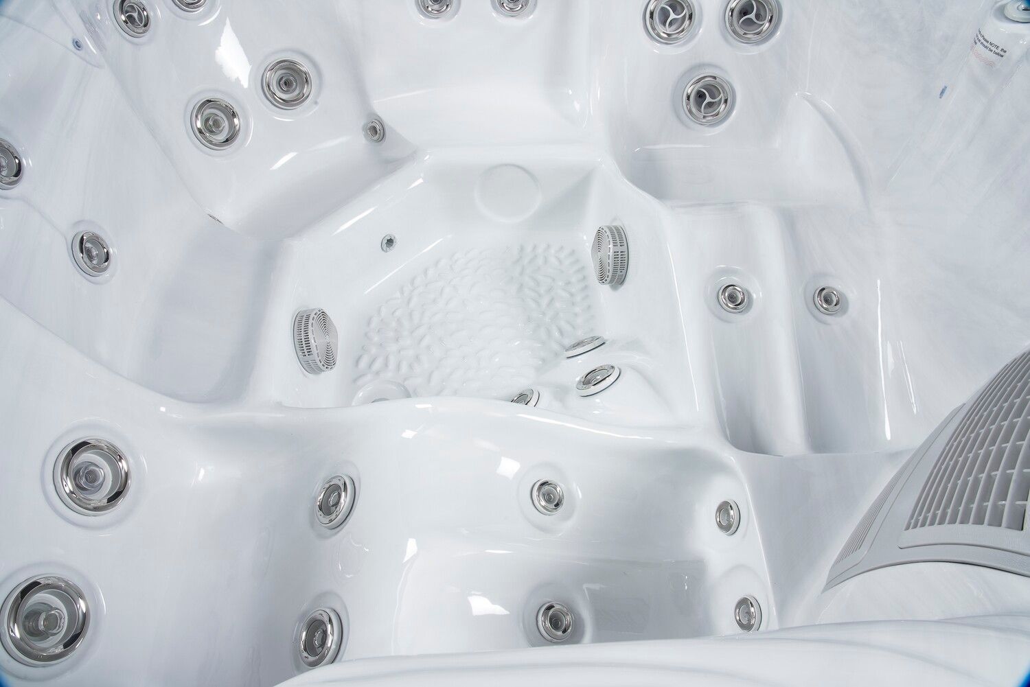 White hot tub interior with multiple jet nozzles.