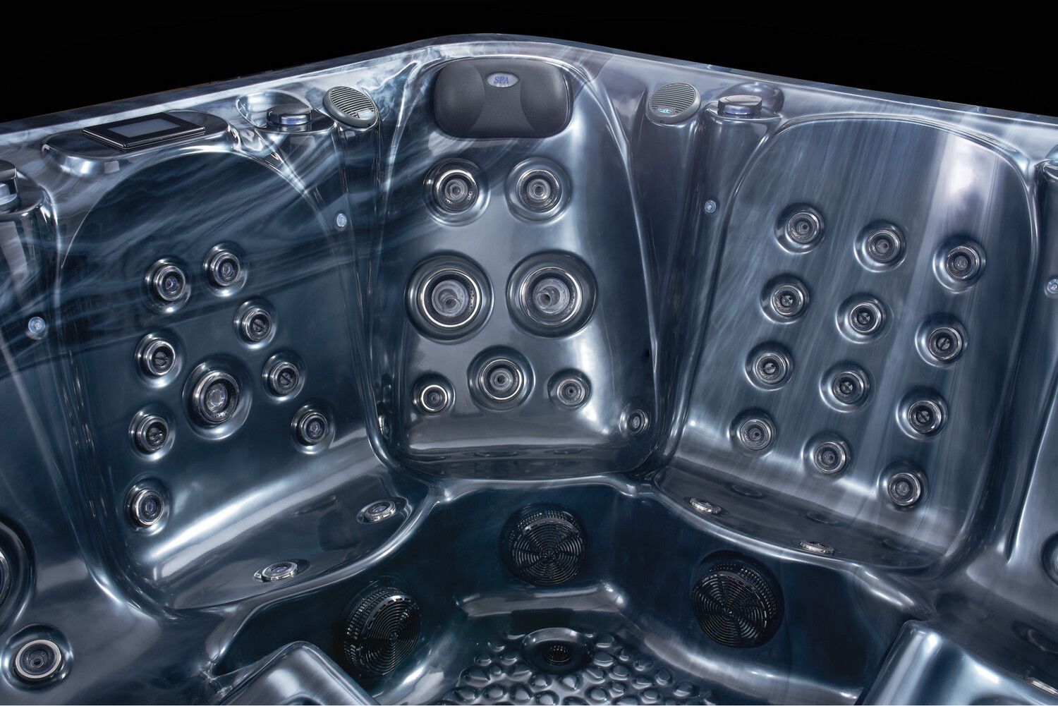 Dark blue hot tub interior with multiple jet nozzles.
