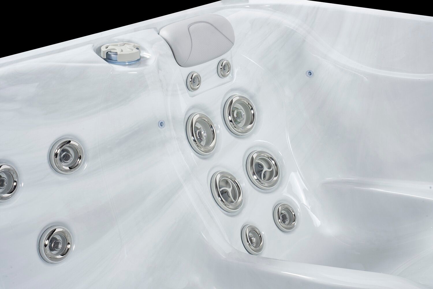White hot tub interior with several jets and a headrest.