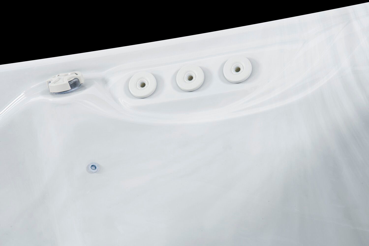 White hot tub interior with three jets and one control valve.
