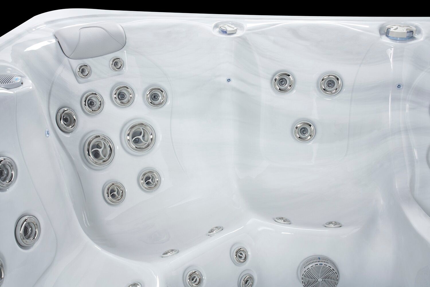 Close-up of a white hot tub interior with multiple jets, headrests, and a contoured design.
