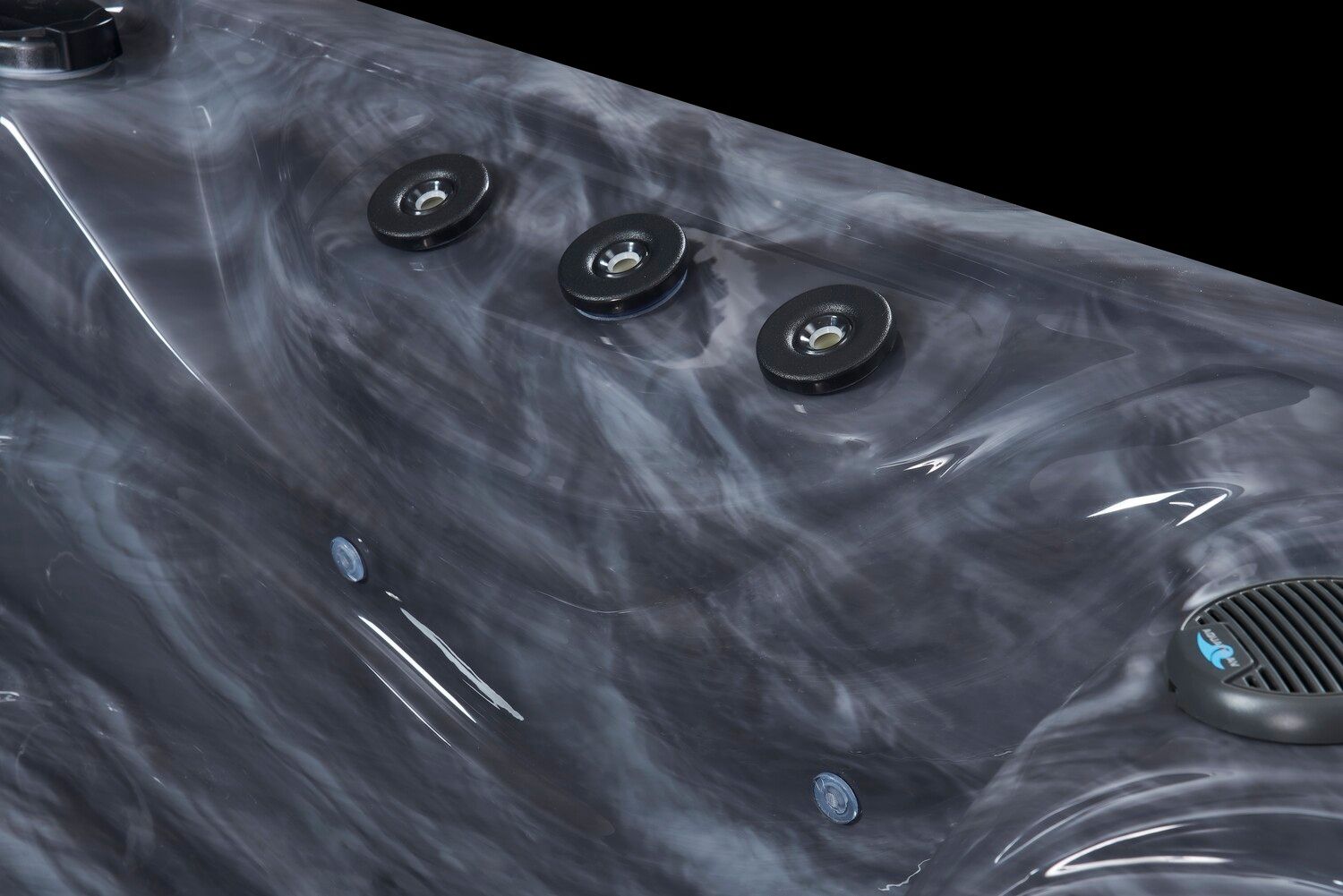 Dark gray marbled hot tub interior with three jet controls and a speaker.