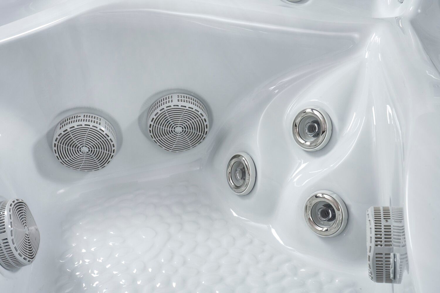 Close-up of a white hot tub interior, featuring multiple jets and seating areas.