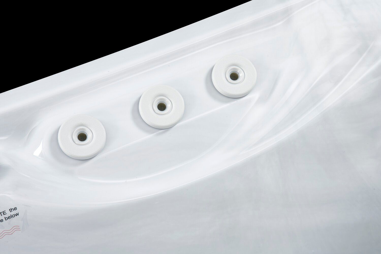 White spa jets recessed into a white tub surface.