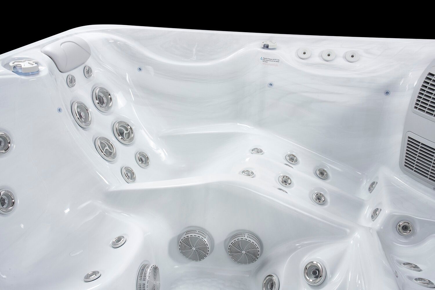 White hot tub interior with multiple jets and built-in steps.