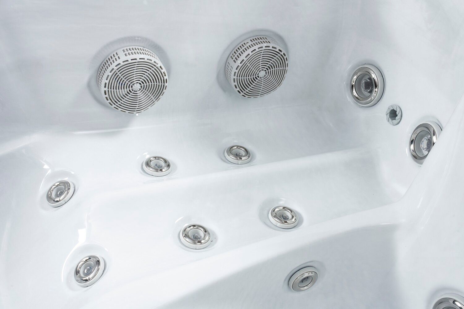Close-up of a white hot tub interior, showing multiple jets and air vents.
