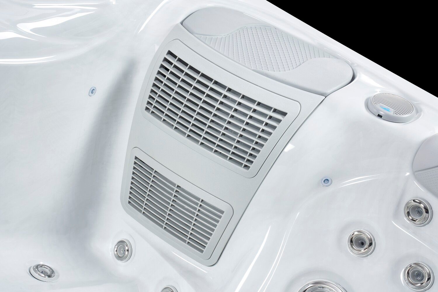 White hot tub interior with a gray control panel and multiple jets.
