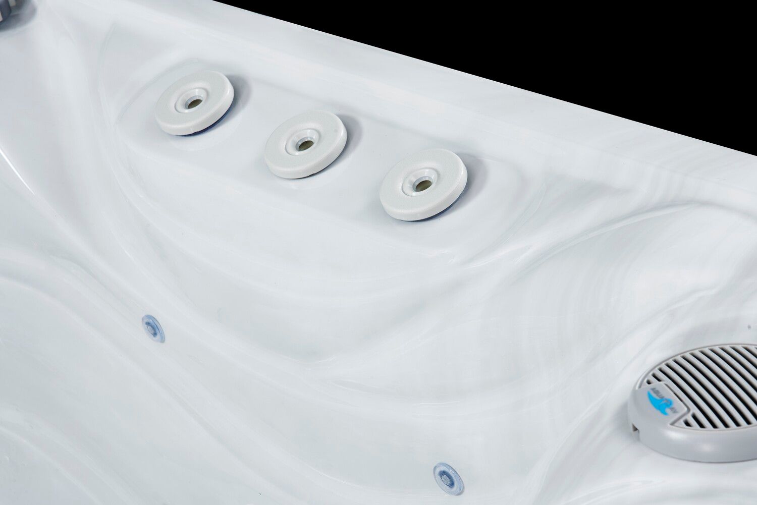 White hot tub interior with three jets and speaker.