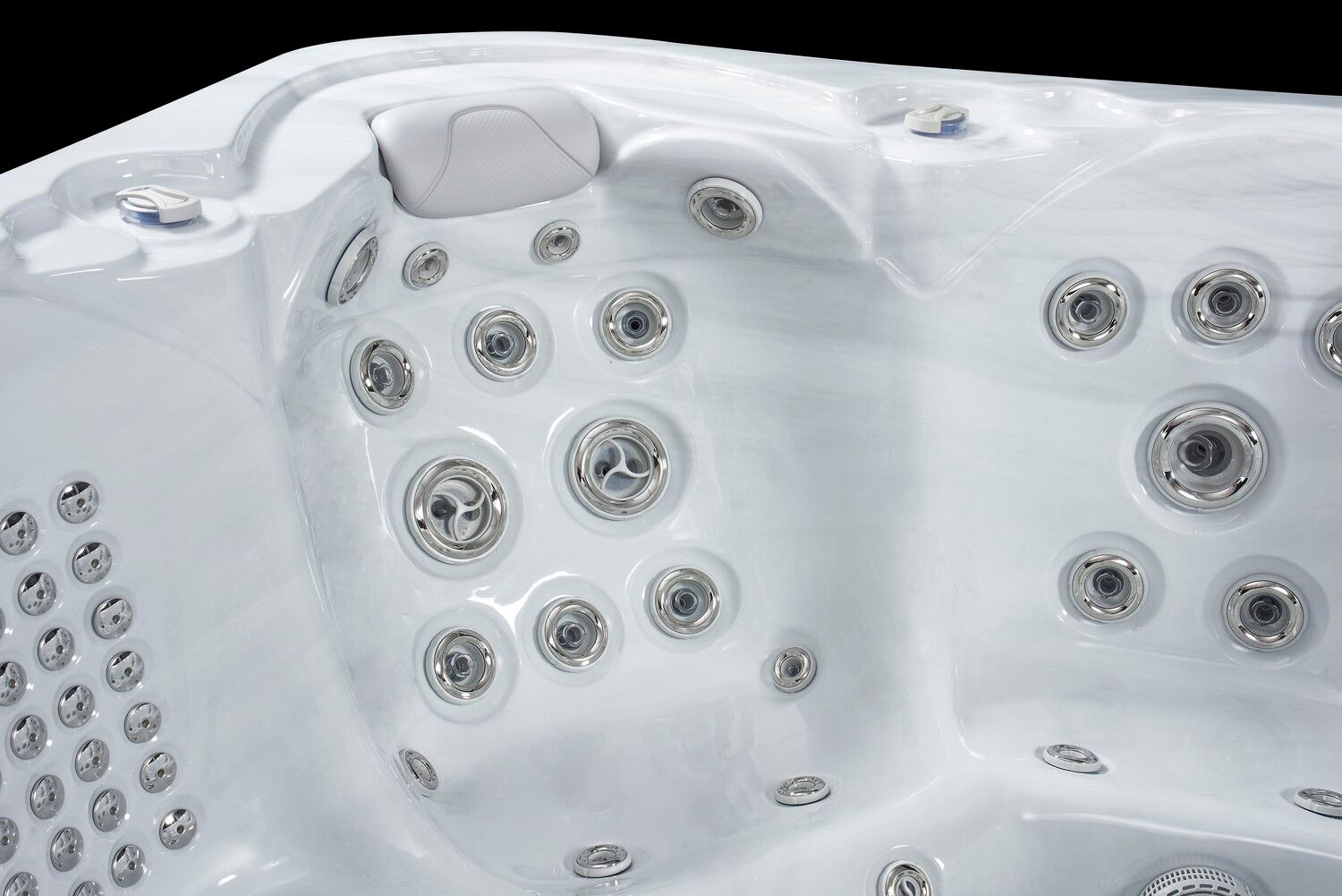 Close-up of a white hot tub interior with various jets for massage and relaxation.